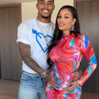 Husband mario lemina smiling with hand on her pregnant belly