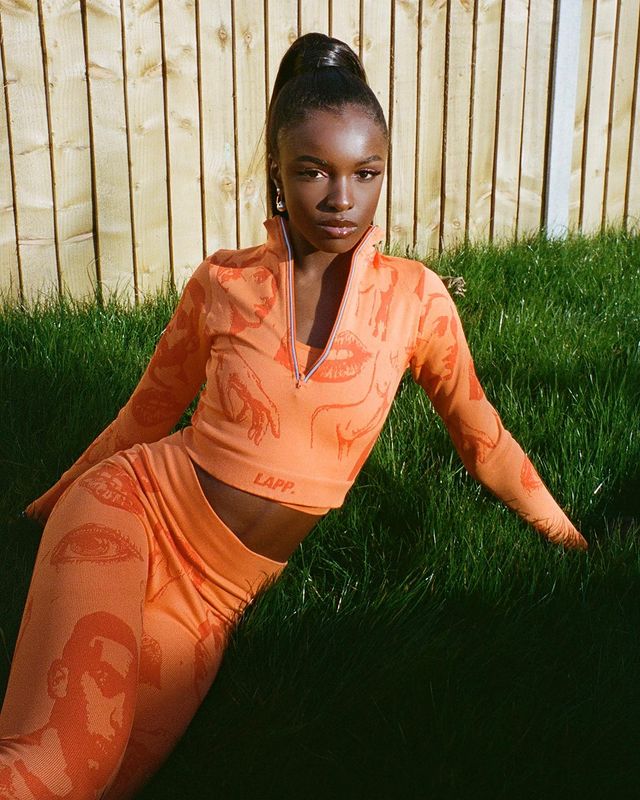 Leomie anderson wearing orange outfit