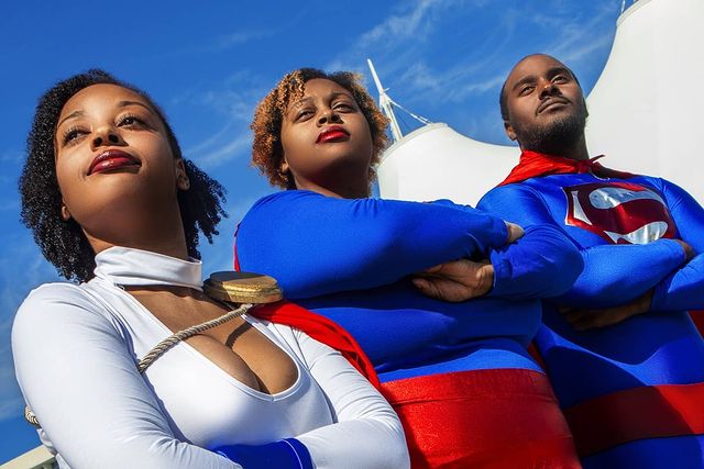 Two black girls as supergirl with black superman