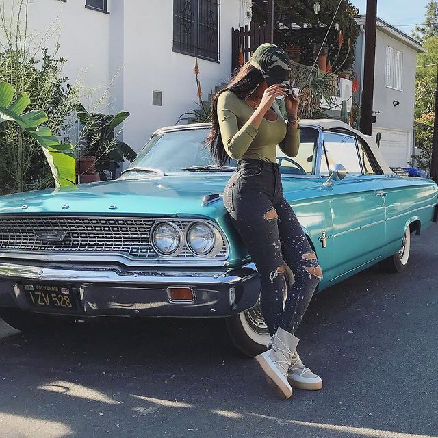 Wearing blue jeans with classic car