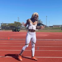 Sha Carri Richardson Wearing Nike White Running Outfit With Orange Shoes
