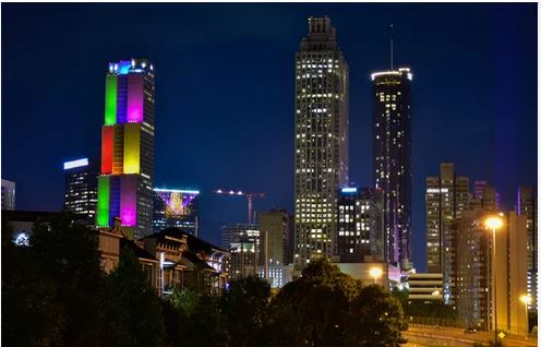 skyscraper lit up with pride colors