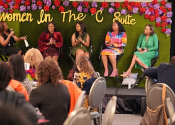 GLAAACC’s 2023 Women in the C-Suite sit onstage together with a colorful bouquet of flowers